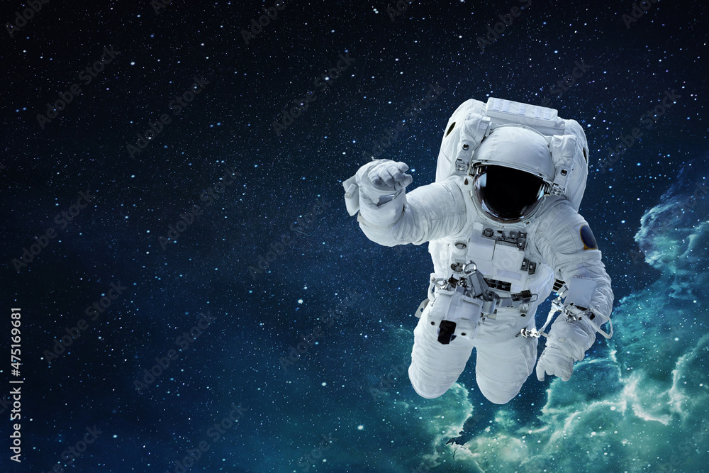Wall mural spaceman astronaut with hamlet flying in blue deep space with stars.