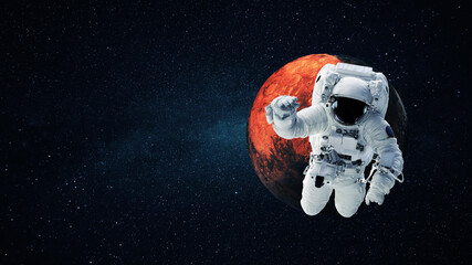 Obraz na płótnie Canvas Astronaut in a space suit flies in open space with the stars and the red planet mars. Journey to Mars, concept. Spaceman travels in space