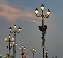 Fototapeta na wymiar lanterns are burning against the blue sky in the park