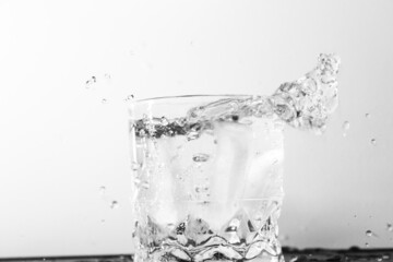 ice cubes dropping into glass
