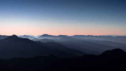 View from the mountains to the hills after sunset. Clear sky.