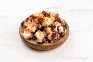 Galician style octopus in wooden plate. Typical appetizer of Galicia, Spain. Pulpo a Feira