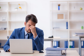 Young male employee working in the office