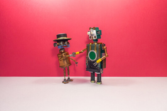 Socialization and humanization of robots using human habits and behavior. Meeting of friends. Funny robots greet and shake hands. Steampunk style characters on pink gray background