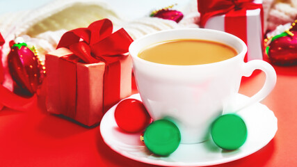 Christmas composition with coffee on red background. Holiday greeting card concept. Cozy winter composition