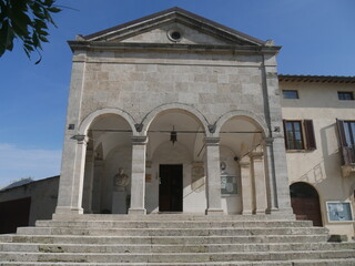 Fototapeta na wymiar St. Martial church in Gracciano dell'Elsa has the facade with the raised entrance with a nineteenth-century loggia