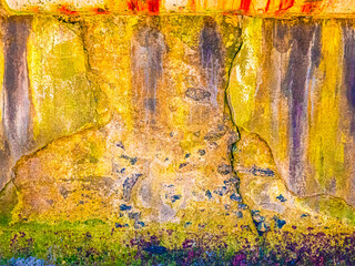 Old cement wall near the sea with stains of dirt, algae and destroyed by time and water. Artistic version. selective foccus.