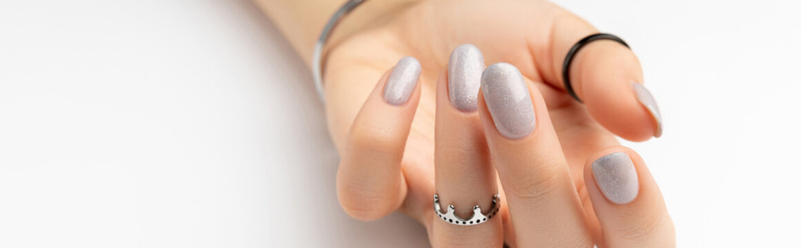 Womans hand with grown manicure on white background with copy space