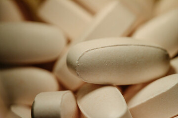 Fototapeta na wymiar Nutritional supplements, lots of brown vitamin pills, concept medicine, background, macro.