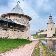 powerful watchtowers along the old fortress wall on the river bank in the ancient Russian city of...