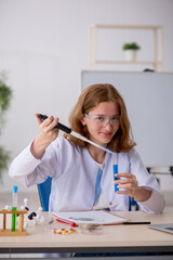 Young female chemist working at the lab
