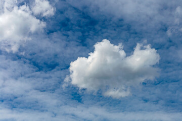 a large cumulus cloud on a background of blurry cirrus clouds as a natural background