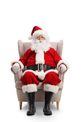 Full length portrait of santa claus resting in an armchair