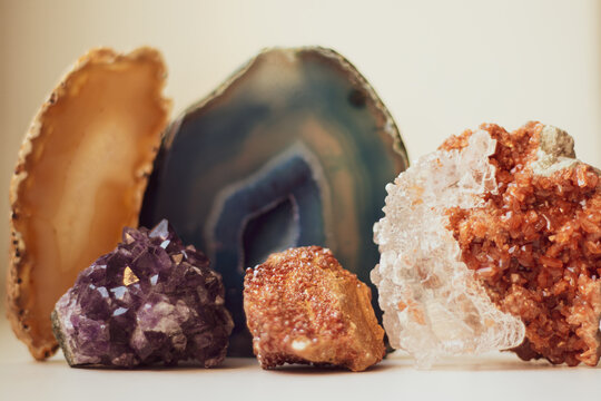 Large blue crystal of agate and druse crystals, cross section isolated on white background. Natural translucent crystal agate surface, collection stones