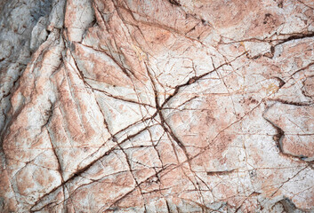 texture detail of pink limestone with grooves