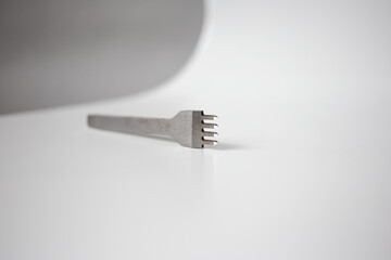 metal tool lies on a white background