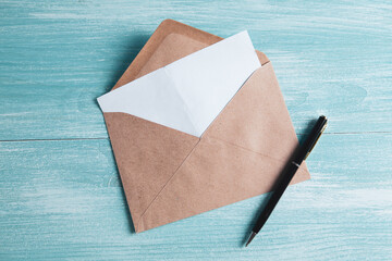 an envelope for letters and a pen on the table