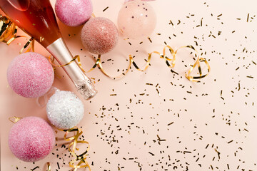 Pink champagne and golden glitter with gift box on a pink background . The concept of a holiday, New Year, Christmas, birthday, Valentine's Day, Mother's Day. Flat lay with a copy of space. 