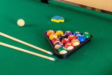 New pool table with balls and pool cues