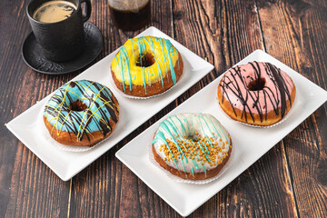 Delicious donuts decorated with different decorations on wooden table