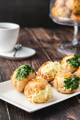 Turkish pastry filled with dill, parsley, cream cheese and cheddar cheese. Turkish name: Sakallı Pogaca or Saçaklı Pogaca