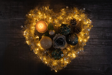 Heart-shaped garland with sparkling lights and a candle