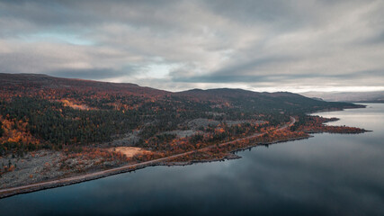 Fototapeta premium Landscape with lake and mountains in Stora Sjöfallet National Park in autumn in Lapland in Sweden from above.