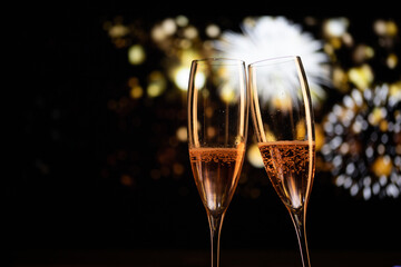 two champagne glasses and festive light happy New Year