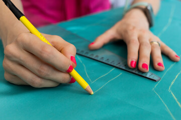 Fashion designer working on her new design draw on the fabrics