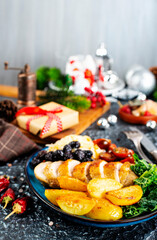 baked chicken breast with potatoes and olives on xmas background