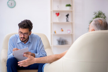 Old man visiting young male psychotherapist