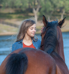 11 year old girl bonding with horse mare