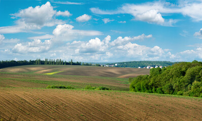 Plowed field and hills in a rural landscape at spring