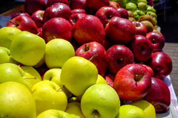 red and golden delicious in a market stall in the street