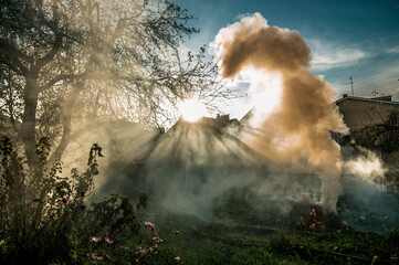 Wind spun clouds of smoke, nice effect. Sun rays through the smoke, morning time