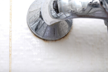 Detail of dirty calcified shower mixer tap and shower hose, faucet with limescale or lime scale on it, close up