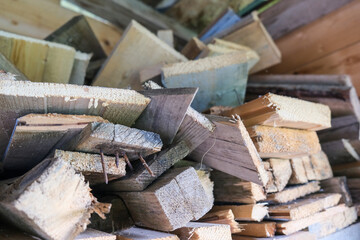 A stack of carpentery waste using as firewood, sustainable, rational and effective use of wood for heating house, low waste and wasteless technologies for saving resources and ecenomy