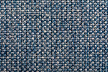 Blue fabric texture. Furniture upholstery textiles. Embossed pattern. Woven fibers. The material is soft touch. Minimalism concept. High detail macro photography for backgrounds or wallpapers.