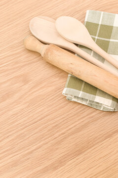 natural solid wood kitchen tools and table napkin on a wooden tabletop