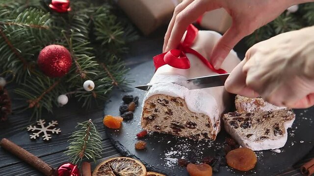 Classical stollen cut into slices. Traditional Christmas festive pastry dessert. Stollen for Christmas.