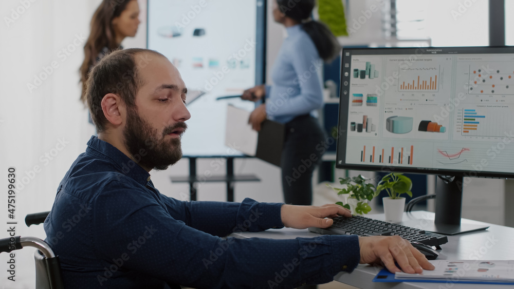 Poster paralysed immobilized invalid worker with disabilities working at computer analysing financial stati