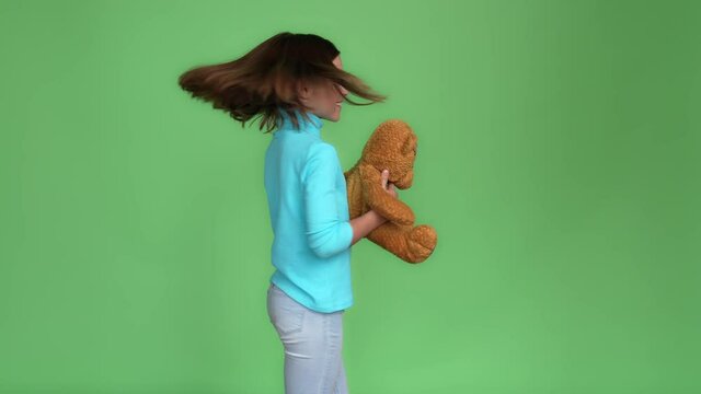 Active schoolchild game dance disco toy bear isolated green color background