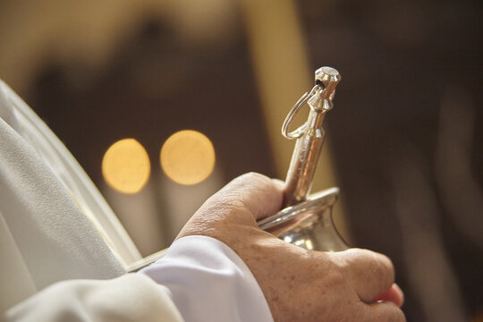 The asperges in the hands of the priest