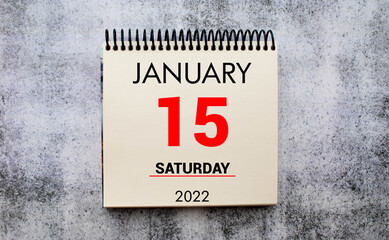 January 15 on a white Notepad .Next to it is a blue clock on a red background.Calendar for January .