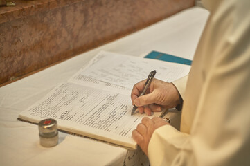 The signature of the priest on the register