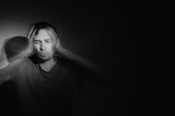 Blurred male portrait in the dark. Male portrait in motion in the dark. 