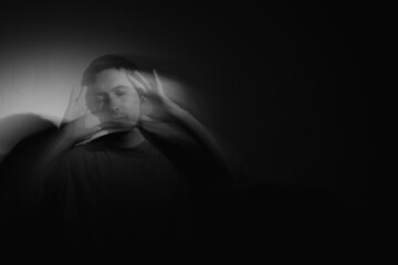 Blurred male portrait in the dark. Male portrait in motion in the dark. 