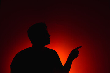 Silhouette of a guy on a red background. Silhouette of a man on a red background.