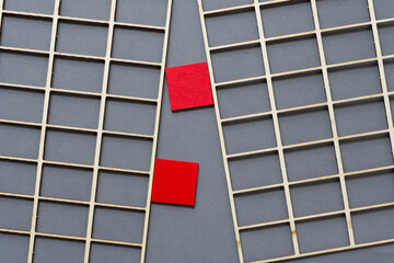 two red squares and lattic on gray paper