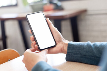 cell phone blank white screen mockup.hand holding texting using mobile on desk at office.background empty space for advertise.work people contact marketing business,technology